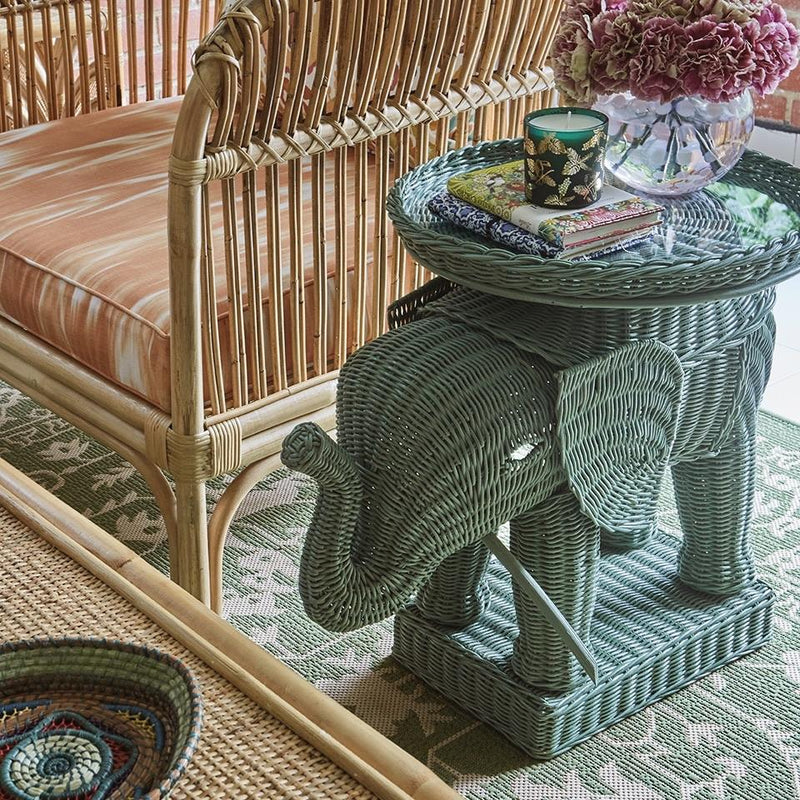 Babar Elephant Side Table. the Babar Elephant side table, is made of handwoven rattan by our artisans in Java, Indonesia. It is available in natural or coloured finishes and comes with a round tray top and thick glass insert to protect the rattan.    The little Ellie is perfect as a side table, as little butler tables on either side of a front door or in a children's bedroom - an extremely versatile and wonderfully tropical piece. 