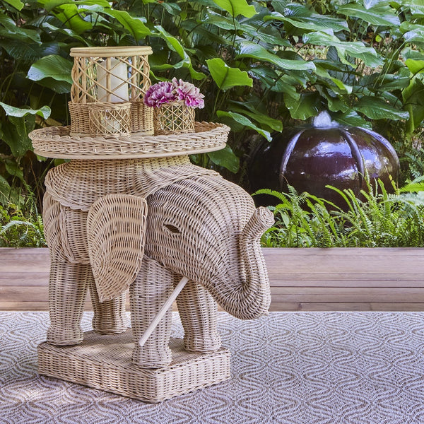 Babar Elephant Side Table. the Babar Elephant side table, is made of handwoven rattan by our artisans in Java, Indonesia. It is available in natural or coloured finishes and comes with a round tray top and thick glass insert to protect the rattan.    The little Ellie is perfect as a side table, as little butler tables on either side of a front door or in a children's bedroom - an extremely versatile and wonderfully tropical piece. 