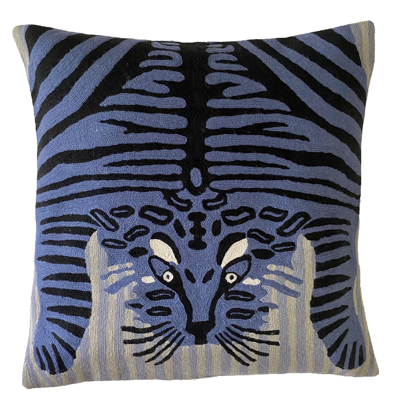 Bengal Tiger Cushion Cover Blue and White. Each cover is made by hand by skilled artisans in Kashmir, the most northern part of India. Using a technique called chainstitch, colourful pure wool yarn is stitched by hook through cotton. Each cover takes up to a week to make.  We are stocking these beautiful cushion covers in a selection of bold colours in very small quantities. This one is a blue and black tiger on light blue and white striped background.  