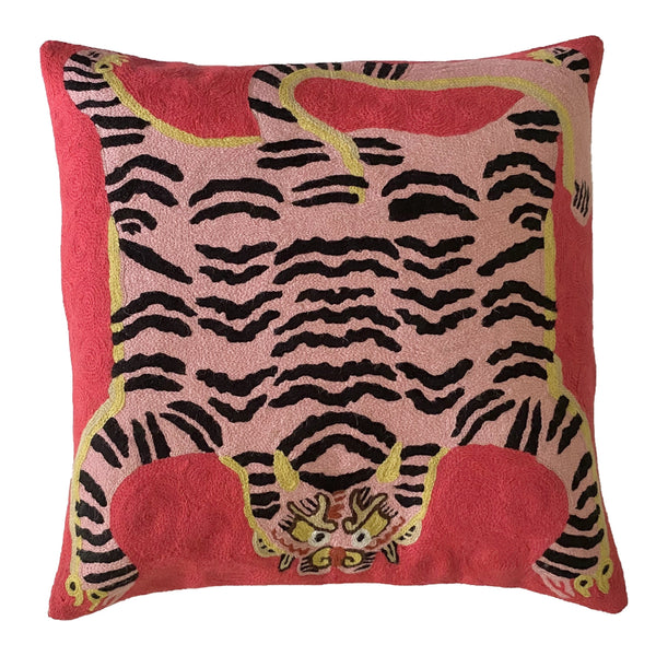 Bengal Tiger Cushion Cover Red and Pink. Each cover is made by hand by skilled artisans in Kashmir, the most northern part of India. Using a technique called chainstitch, colourful pure wool yarn is stitched by hook through cotton. Each cover takes up to a week to make.  We are stocking these beautiful cushion covers in a selection of bold colours in very small quantities. This one is a pink tiger with black stripes on a traditional red background. 